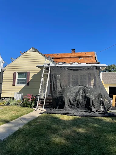 House with the roof deck exposed and the porch covered during a tear-off